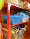 A nursery playschool equipment cupboard boxes on shelves Royalty Free Stock Photo