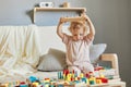 Nursery room filled with exploration. Building blocks of learning. Fun activities for young children. Funny wavy haired blonde Royalty Free Stock Photo