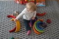 Nursery school - baby playing with wood rainbow Royalty Free Stock Photo