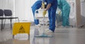 Nurses mopping floor and making bed in empty hospital ward Royalty Free Stock Photo