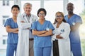 Nurses, portrait and team of doctors with arms crossed standing together in hospital. Face, confident and medical Royalty Free Stock Photo