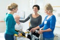 nurses practicing procedure to lift disabled patient from bed Royalty Free Stock Photo