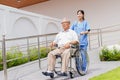 Nursing Home Care concept. asian Young nurse disabled elderly man. Nurse, care home and elderly man with disability in a