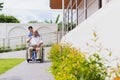 Nursing Home Care concept. asian Young nurse disabled elderly man. Nurse, care home and elderly man with disability in a