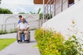 Nursing Home Care concept. asian Young nurse disabled elderly man. Nurse, care home and elderly man with disability in a