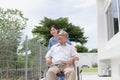 Nursing Home Care concept. asian Young nurse disabled elderly man. Nurse, care home and elderly man with disability in a