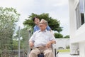 Nursing Home Care concept. asian Young nurse disabled elderly man. Nurse, care home and elderly man with disability in a