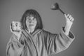 Nursing home. Woman with long hair hold alarm clock and spoon. Royalty Free Stock Photo