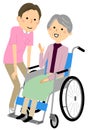 Elderly people in wheelchairs and the caregiver