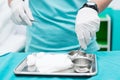 Nursing student prepare Sterile wound Kit for her patient. Closed-up to hand with soft focus. Royalty Free Stock Photo