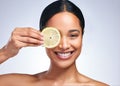 Nurture your intellect. Portrait of an attractive young woman posing with a sliced lemon against a grey background.