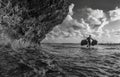 Indonesian farmer carrying seaweed collected from his sea farm to house for drying in morning, Nusa Penida, Indonesia