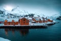 Nusfjord, small fishing village in Norway, lofoten, during amazing winter evening, ships, snow and yellow cabins. Royalty Free Stock Photo