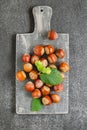 Nut abundance. Hazelnuts on a gray wooden board on a gray slate background. Farmed organic ripe hazelnuts.