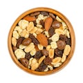 Nut chocolate mix, sweet snack food, in a wooden bowl, close up Royalty Free Stock Photo