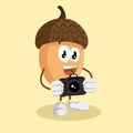 Nut mascot and background with camera pose Royalty Free Stock Photo