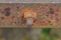 nut on a rusty bolt on a brown iron wall Royalty Free Stock Photo