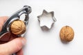 Nutcracker, walnuts and star shaped cookie cutter Royalty Free Stock Photo