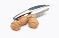Nutcracker and walnuts on white Royalty Free Stock Photo