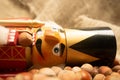 Nutcracker wooden figure of a soldier for cracking nuts on the background of scattered nuts. Traditional symbol of Christmas and