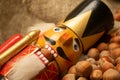 Nutcracker wooden figure of a soldier for cracking nuts on the background of scattered nuts. Traditional symbol of Christmas and Royalty Free Stock Photo