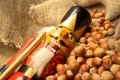 Nutcracker wooden figure of a soldier for cracking nuts on the background of scattered nuts. Traditional symbol of Christmas and