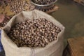 Nutmeg beans in burlap sack. Whole beans packed in bulk bags. Raw beans. Bulk beans