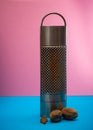 Nutmeg grater on a pink and blue background cooking concept , spices