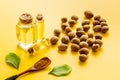 Nutmeg oil - aromatherpy concept - on yellow background Royalty Free Stock Photo