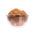 Nutmeg powder in glassy saucepan on white background.