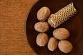 Nutmeg on a saucer with a nut grater.