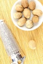 Nutmeg seeds in a small white bowl