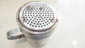 CINNAMON OR CHOCOLATE SHAKER. TOP VIEW, MESSY, USED, DINGED, HIGH USE, OLD, CLASSIC,