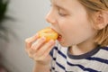 Nutrient-rich break: A child savors the sweetness of a ripe yellow plum, enjoying a nutritious fruity interlude Royalty Free Stock Photo