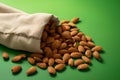 Nutrient rich display almonds atop an eco canvas bag, green backdrop