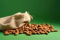 Nutrient rich display almonds atop an eco canvas bag, green backdrop