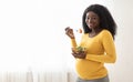 Happy pregnant black woman eating fresh salad at home Royalty Free Stock Photo