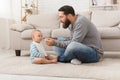 Little boy refuses to eat making unpleasant grimace, isolated over white