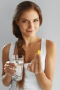 Nutrition. Healthy Lifestyle. Woman Holding Pill With Fish Oil O