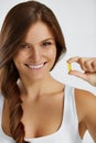 Nutrition. Healthy Lifestyle. Woman Holding Pill With Fish Oil O