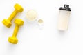 Nutrition for muscle growth. Scoop of protein near shaker and dumbbell on white background top view copy space Royalty Free Stock Photo