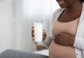 Nutritional Needs During Pregnancy. Black Pregnant Woman Holding Glass Of Milk, Cropped