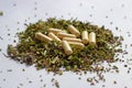 Nutritional supplements pills and capsules on dried herbs background. Alternative herbal medicine, naturopathy and homeopathy
