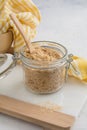 Nutritional Yeast in a glass jar. Vegan food concept