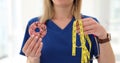 Nutritionist compares donut and measuring tape and discusses calorie intake and exercise