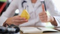 Nutritionist doctor healthy lifestyle concept holds fresh organic pear fruit Royalty Free Stock Photo