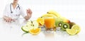 Nutritionist doctor shows the pill in his hand at the desk office with fruits, tape meter and orange juice, healthy and balanced