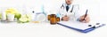 Nutritionist doctor writes the medical prescription for a correct diet on a desk with fruits, drugs and supplements, web banner Royalty Free Stock Photo