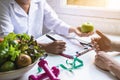 Nutritionist giving consultation to patient with healthy fruit and vegetable, diet concept