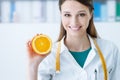 Nutritionist holding a sliced orange Royalty Free Stock Photo